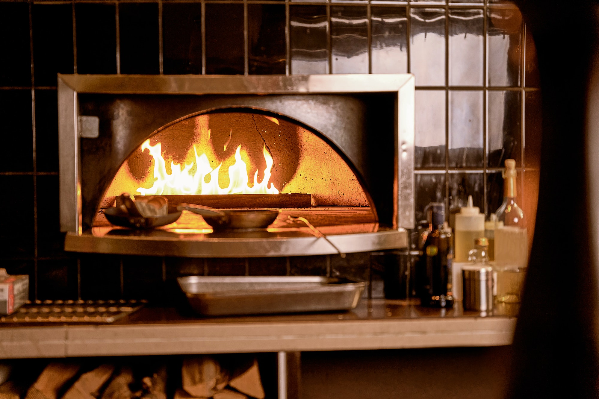 Pans standing in oven with fire in a restaurant