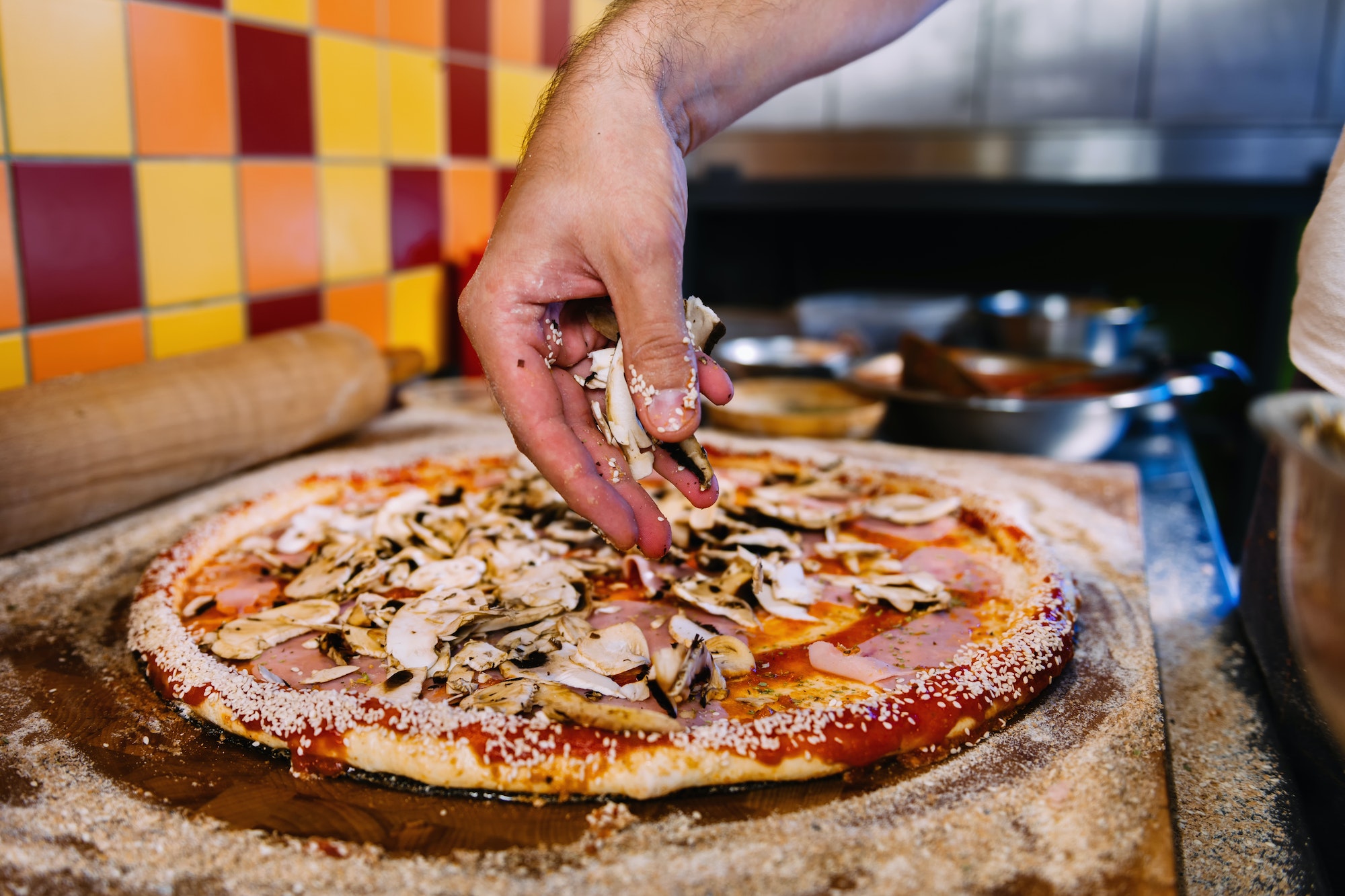 Putting Mushrooms On Pizza In Pizza Restaurant